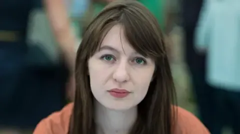 Sally Rooney states she cannot enter the UK over potential arrest